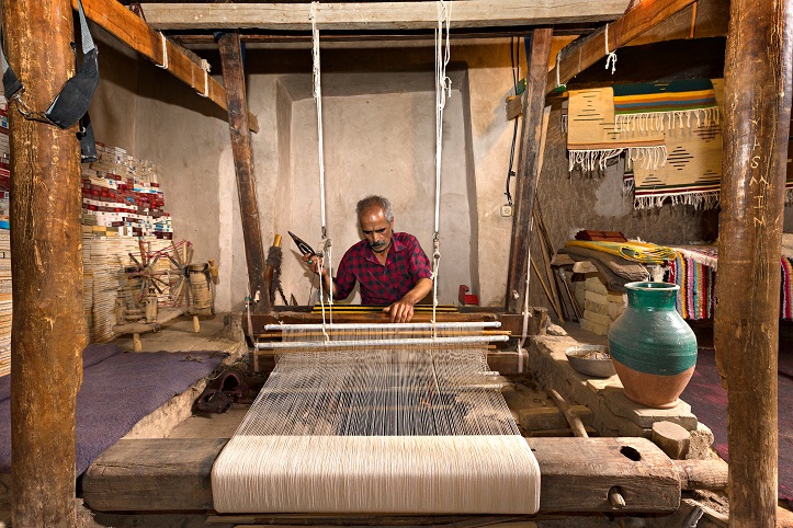 Iranian man weaves fabrics known as Aba, in traditional way, in the twon of Nain, Iran.